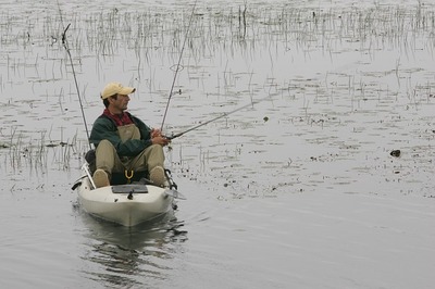Angler catching fish from kayak