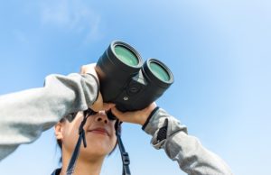 girl with compact zoom binoculars