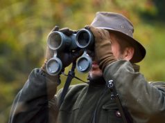 hunter using binoculars