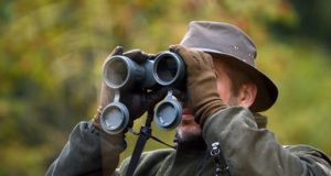 hunter looking through binoculars