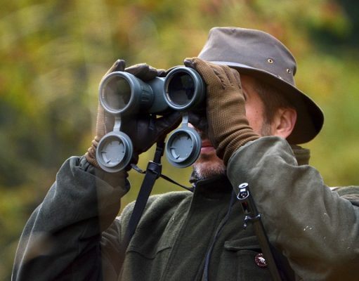hunter looking through binoculars
