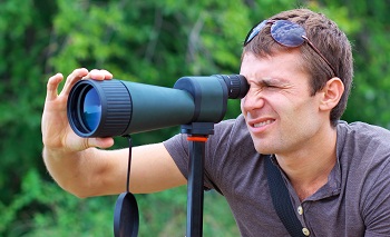 Man who is watching in spotting scope