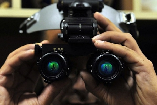 A person holding the night vision goggles