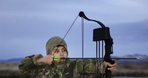 kid with youth compound bow