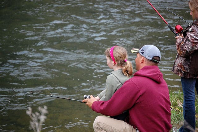 father fishing with daughter