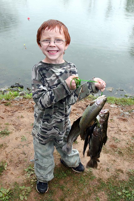 young angler with a bunch of trout