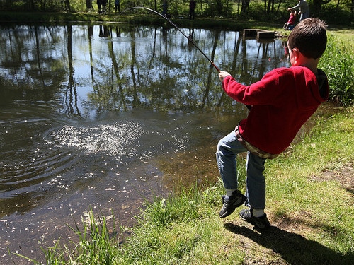 young angler pulling the fishing rod