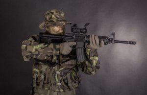 man in camouflage holding M4 carbine