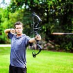 Man shooting compound bow