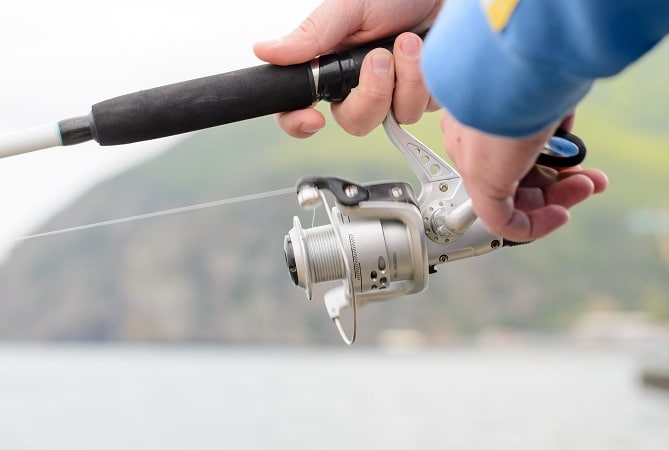 Fisherman using a rod and spinner reel