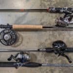 Main types of fishing reels on rods laying on floor