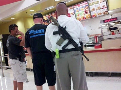 man carrying airsoft gun in a food joint