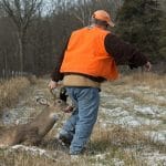Hunter dragging a deer