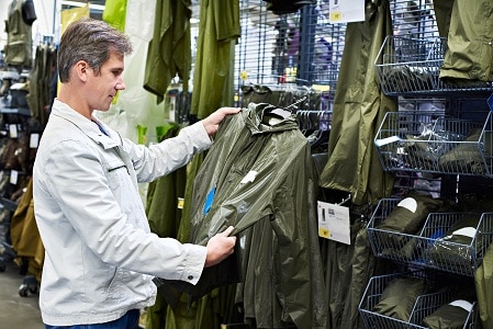 man choosing raincoat