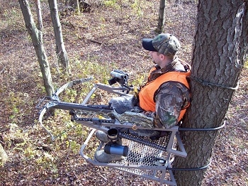 hunter with crossbow on treestand