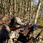 Hunter aiming a rifle