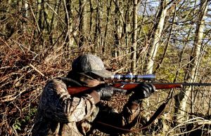 hunter aiming a rifle