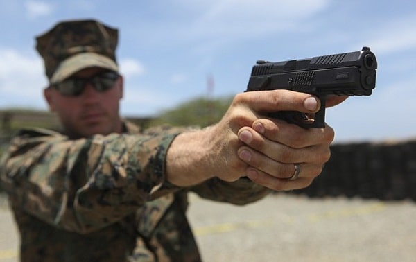 man aiming pistol