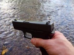 man holding Glock 43 with sight