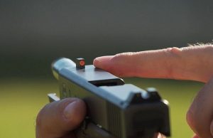 man holding glock 19 with sight