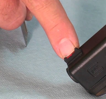 man pointing Glock front sight