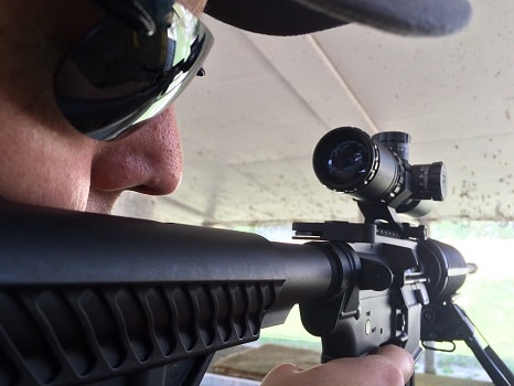 Man aims rifle at shooting range