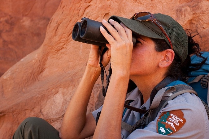 ranger looking through inexpensive binoculars