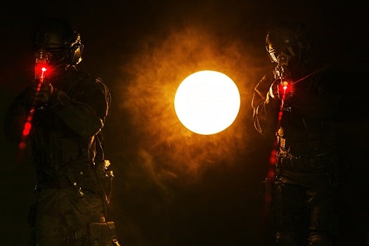 shooters using red laser sights in the dark