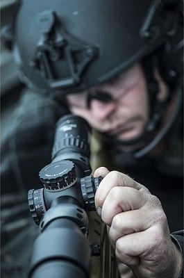 soldier adjusting scope knob