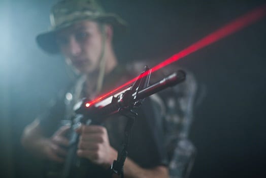 soldier holding M16 with laser sight