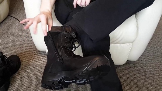 man fitting tactical boots