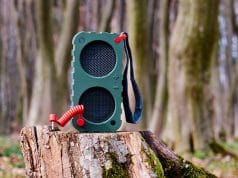 Portable Speaker on a tree stump in the woods