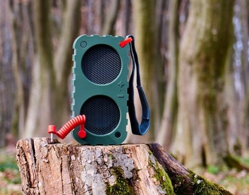 Portable Speaker on a tree stump in the woods