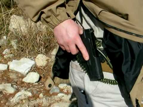 man getting gun from side zipper tactical jacket
