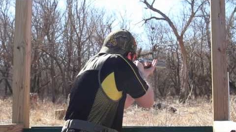 man shooting with a shotgun