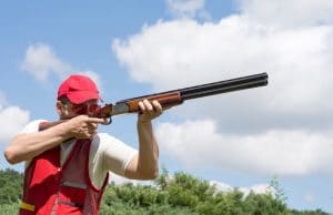 man wearing shooting vest with gun