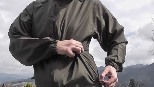 man zipping tactical jacket pocket