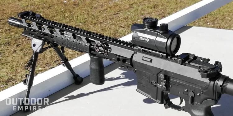 Newship RGB dot sight on AR-15 on table at range