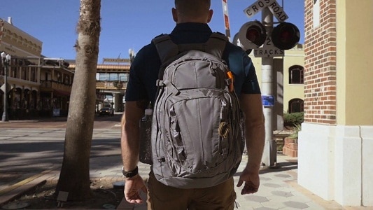 man walking with tactical backpack