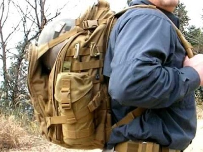 man with tactical backpack side view
