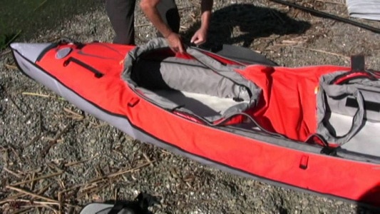 man deflating kayak