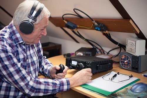 Enthusiastic middle-aged radio-amateur at his workplace