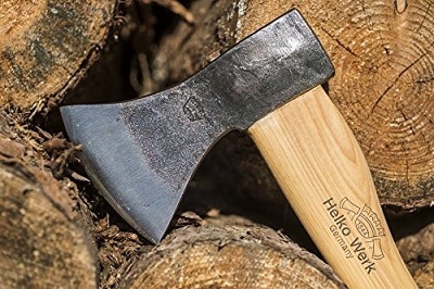Axe against a pile of logs