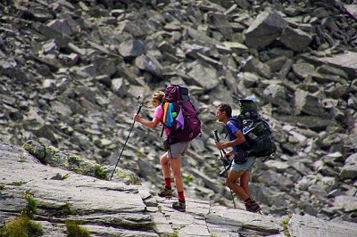 couple hiking rock mountain