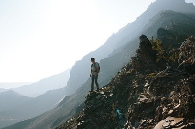 hiker at the edge of rocky mountain