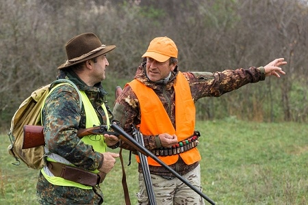 Hunters talking on woodland