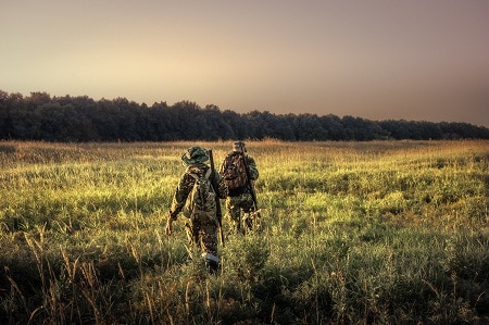 Hunters walking towards forest