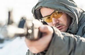 man aiming a rifle
