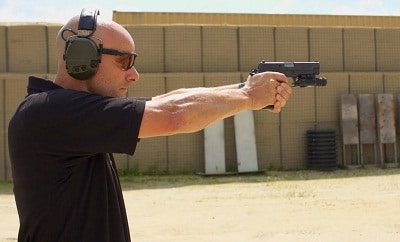 man aiming pistol for target practice