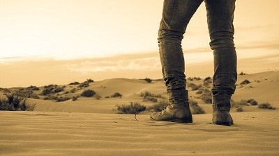 man standing in the heat of desert